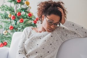 Pensive and lonely black woman during christmas celebration days