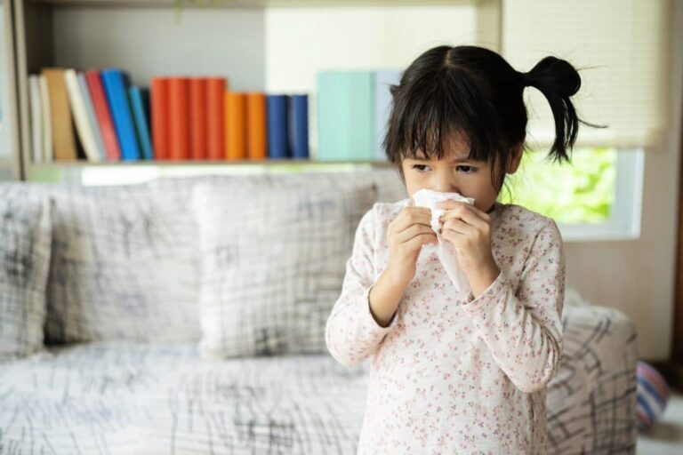 girl blowing nose allergies