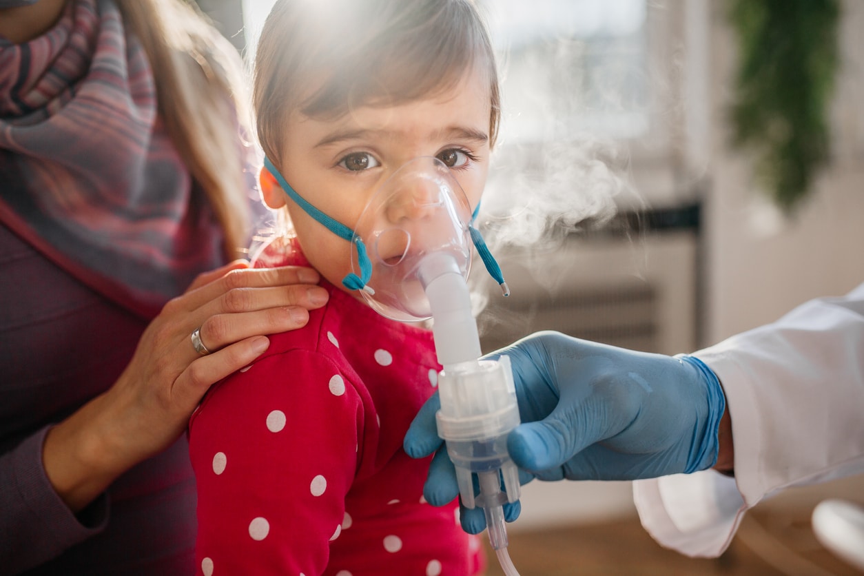 Young child does breathing treatment at doctor's office