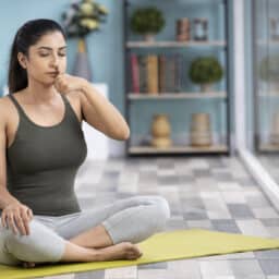 Woman on a yoga mat breathing through her nose